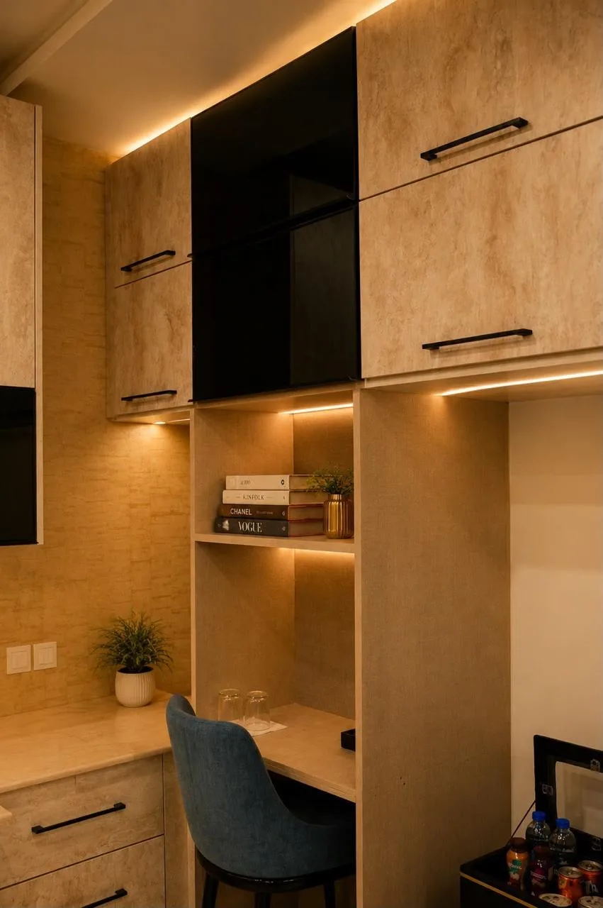 Kitchenette and desk nook with backlit shelving and stacked books